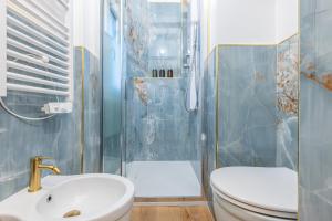 a bathroom with a shower and a toilet and a sink at Canva Suite near Sacco Hospital in Milan +9 photos