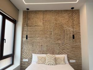 a bedroom with a large wooden wall behind a bed at Apartments Vent de Vela in Valencia