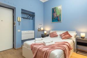 a bedroom with a large bed with blue walls at Canva Suite near Sacco Hospital in Milan