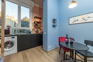 a kitchen with a table and a washing machine at Canva Suite near Sacco Hospital in Milan