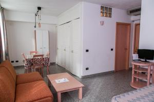 a living room with a couch and a table at L'incanto Di Boccadarno in Marina di Pisa