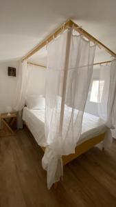 een slaapkamer met een hemelbed bij A casa di Leia in Borgo