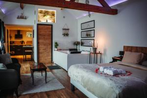 a bedroom with a large bed and a kitchen at La suite BLR in Villemandeur