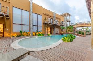 a swimming pool in front of a building at Pousada Chaves do Paraíso in São Miguel do Gostoso