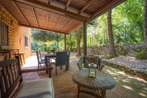 an outdoor patio with a table and chairs at Santa Colomba House, Siena, Nature And Pool in Monteriggioni