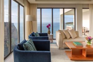 a living room with a couch and chairs and a table at Tivoli Carvoeiro in Carvoeiro