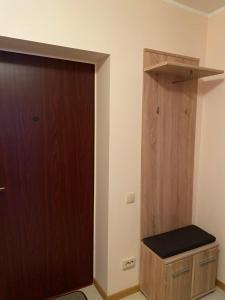 a room with a wooden door and a wooden stool at Dzīvoklis Bauskā in Bauska