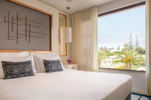 a bedroom with a large bed with a large window at Tivoli Carvoeiro in Carvoeiro