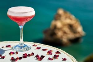 a glass of wine sitting on top of a cake at Tivoli Carvoeiro in Carvoeiro