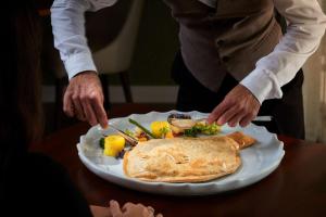 a plate of food with a tortilla on a table at Tivoli Carvoeiro in Carvoeiro