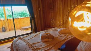 a bedroom with a bed with a stuffed animal on it at L'Entre2rêves in Saint-Maigrin