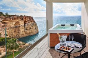 a room with a view of the ocean at Tivoli Carvoeiro in Carvoeiro