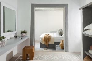 a bedroom with a bed and a mirror at Coco-Mat Eco Residences Serifos in Vayiá