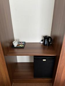 a wooden counter with a coffee pot and a plate on it at 'T centrum Reusel in Reusel