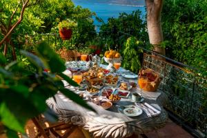 a table with food and drinks on a balcony at Fidanka Hotel in Kalkan