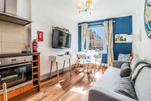 a living room with a couch and a table at Cozy Apt at Edinburgh Castle, Parking in Edinburgh