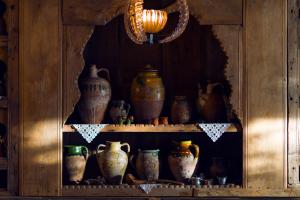 a shelf with vases and other pottery on it at Fidanka Hotel in Kalkan