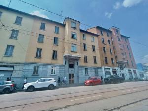 a group of cars parked in front of a building at Canva Suite near Sacco Hospital in Milan