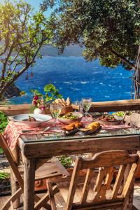 a table with plates of food and wine glasses on it at Fidanka Hotel in Kalkan