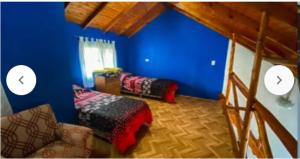 a room with blue walls and a couch and a bed at Duplex Brisas del Mar 2A in Barrio Félix U Camet
