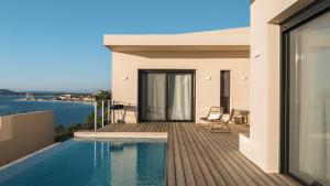 a house with a swimming pool on a balcony at VILLA ARMONIA 3 bed family villa with private pool in Paleros