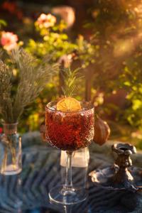 a drink in a wine glass on a table at Fidanka Hotel in Kalkan