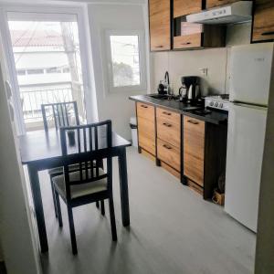 a kitchen with a table and chairs and a refrigerator at 55sm apartment Voula 4pax in Athens