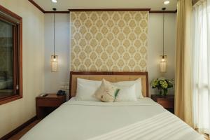 Ένα ή περισσότερα κρεβάτια σε δωμάτιο στο Sunset Westlake Hanoi Hotel