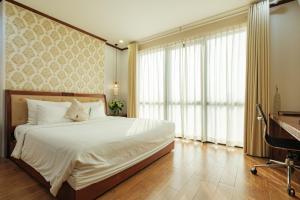 Ένα ή περισσότερα κρεβάτια σε δωμάτιο στο Sunset Westlake Hanoi Hotel