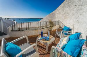 a balcony with chairs and a table with a view of the ocean at Ideal Property Mallorca - Dali 127 in Port d'Alcudia