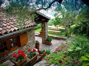 a stone house with flowers on the side of it at Villa Bella in Grožnjan +44 photos