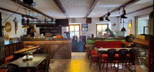 a restaurant with a table and chairs in a room at Apparthotel - Pension Ammertaler Hof in Saulgrub