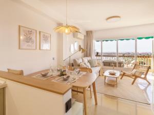 a kitchen and living room with a table and a couch at Apartamento Sea View Aguadulce in Aguadulce