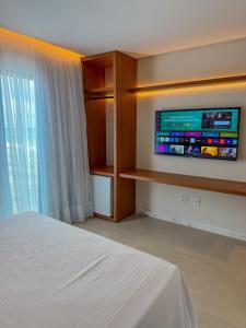 Cama ou camas em um quarto em Porto Suítes Natal Hotel