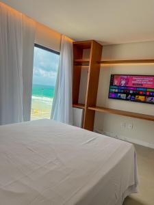 Cama ou camas em um quarto em Porto Suítes Natal Hotel