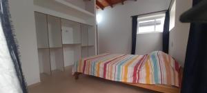 a bedroom with a bed and a window in it at los QUISPER in San Bernardo