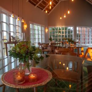 a dining room with a table with candles and chairs at Humbi Farm in Xai-Xai