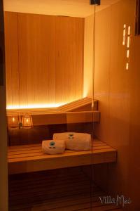 two towels sitting on a shelf in a bathroom at Luxury Villa Mei - SPA, Pool & Jacuzzi in Civitanova Marche