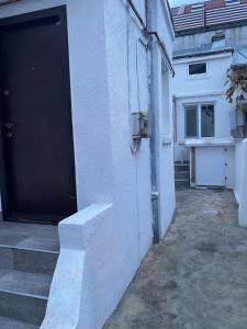 an open door of a building with stairs next to it at House with 2 bedrooms in Bucharest