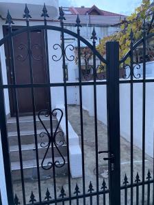 a gate to a house with a door and stairs at House with 2 bedrooms in Bucharest +4 photos