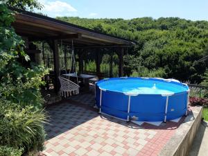 a large hot tub on a patio with a pavilion at Guest House Bee in Visoko