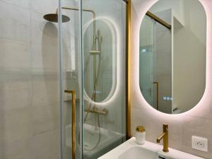 a bathroom with a shower with a sink and a mirror at Studio du port - Porte marine in Antibes