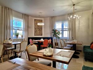 a living room with tables and chairs and a dining room at Hermes Resort Hotel in Truskavets