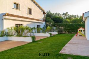 a yard with a house and a playground at Lussuosa Villa con piscina a Porto Rotondo in Cugnana