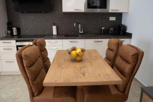 a kitchen with a wooden table with a bowl of fruit at Sunrise Room 1 in Igoumenitsa