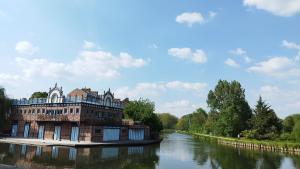 a building sitting on the side of a river at T2 a stone's throw from Gare Amiens in Amiens