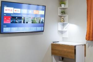 a flat screen tv hanging on a wall at T2 a stone's throw from Gare Amiens in Amiens