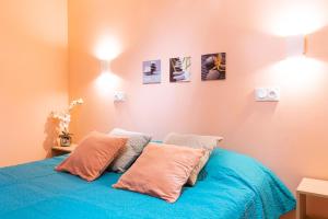 a bedroom with a blue bed with two pillows at T2 a stone's throw from Gare Amiens in Amiens