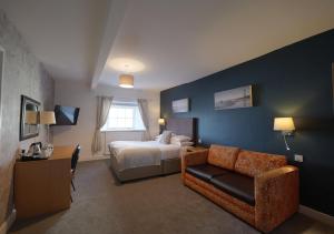 a hotel room with a bed and a couch at THE LORD NELSON HOTEL in Pembrokeshire +68 photos
