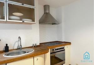 a kitchen with a sink and a stove at Surf Room - 5 Minutes to Sopot Molo & Seaside in Sopot